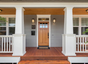 A custom wooden front entry door on a porch